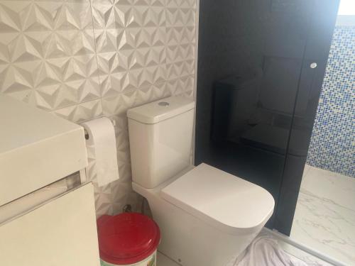a bathroom with a toilet and a glass shower at Suite 2 próx ao autódromo in Sao Paulo