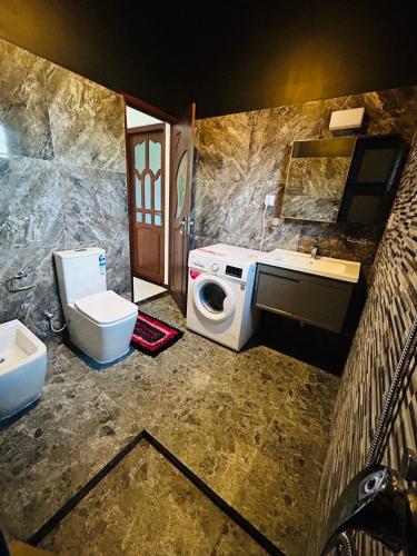 a bathroom with a sink and a toilet and a mirror at Royal Villa in Marawila