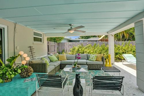 a patio with a couch and a table and chairs at New! Waterfront Heated Pool, Fishing Pier, Designer Touches, 2mi to Beach in Fort Lauderdale