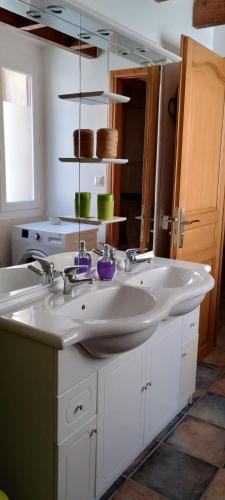 une salle de bain avec un lavabo blanc et un miroir dans l'établissement Le triplex Saint Aphrodise, terrasse au calme et parking gratuit, à Béziers