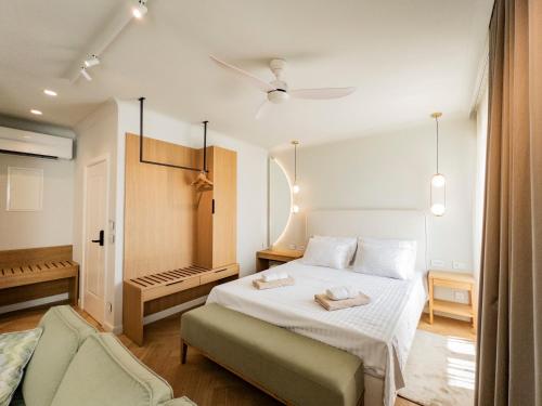 a bedroom with a white bed and a chair at Topaz Rooms in Hvar