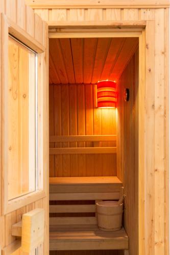 a small sauna with a light in a wooden cabin at Xenones Filotera in Imerovigli