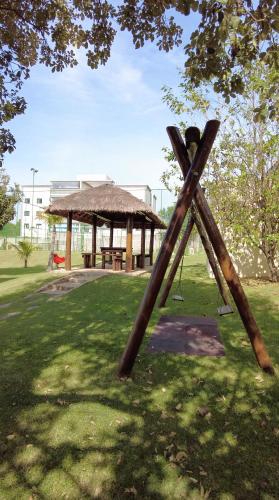 a wooden swing set in a park with a pavilion at Vinhedo Plaza Hotel in Vinhedo