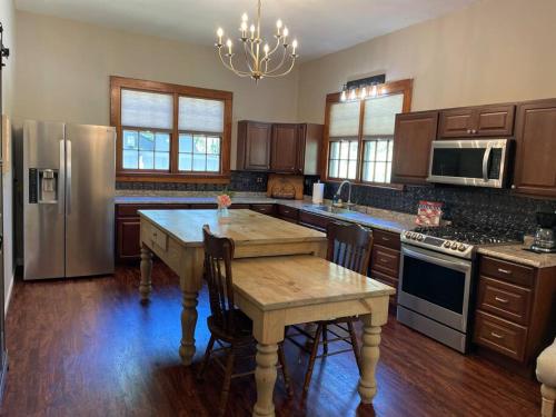a kitchen with a wooden table and a refrigerator at Victorian mini mansion near Lake Greenwood in Cross Hill