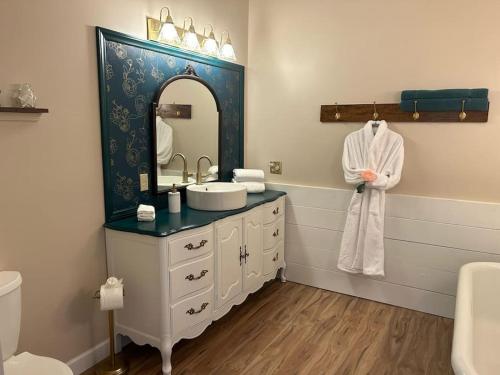 a bathroom with a sink and a mirror at Victorian mini mansion near Lake Greenwood in Cross Hill
