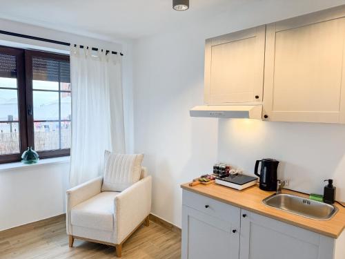 a kitchen with a desk and a chair and a sink at MERSEA in Ustka