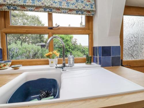 a sink in a kitchen with a window at Hawthorn in Keighley