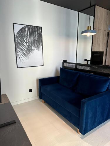 a living room with a blue couch in a room at ALEKSANDRA 4 - Blue in Kielce