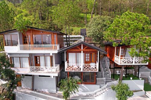 an aerial view of a house with balconies at Koro Treehouse Resort Luxury Wooden Cottages and Villas with Private Pool in Kasauli