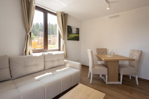 a living room with a couch and a table at Vila Oaza mira Golija in Golija