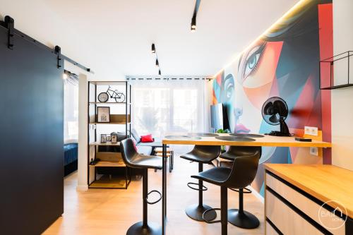 a room with a desk and two bar stools at Picasso Apartment - Free Parking Place in Sosnowiec