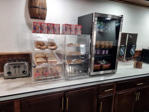 a kitchen counter with an open refrigerator with food at Howard Johnson by Wyndham Springerville in Springerville