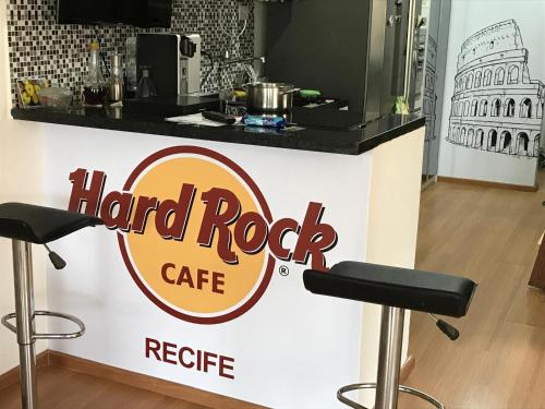 a sign for a hard rock cafe with two bar stools at Olinda Home in Olinda