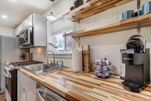a kitchen with a sink and a counter at Baby Blue Cottage Downtown Hot Tub BBQ Fire Pit in Colorado Springs