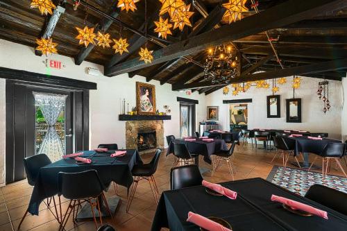 a dining room with tables and chairs and a fireplace at The Paloma Resort in Palm Springs