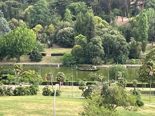 a park with a boat in the water and trees at Suite Laghetto EUR in Rome