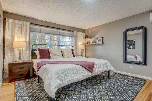 a bedroom with a large bed and a window at Blackstone Trails Downtown w BBQ & Fire Pit in Colorado Springs