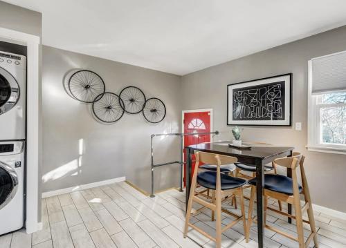 a kitchen with a table and two bikes on the wall at Blackstone Trails Downtown w BBQ & Fire Pit in Colorado Springs