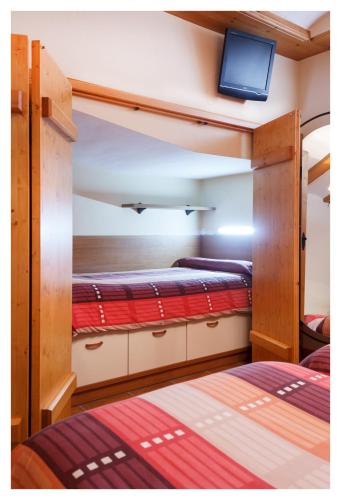 two bunk beds in a room with a tv on top at El Casal de Nicolás in Fortanete