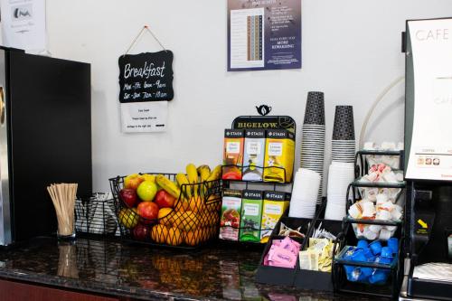 a counter with fruit and other food items on it at Red Lion Inn & Suites Vancouver in Vancouver