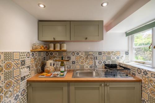 a kitchen with a sink and a counter top at Grade 2 Cottage 1 bedroom, Ludlow centre in Ludlow