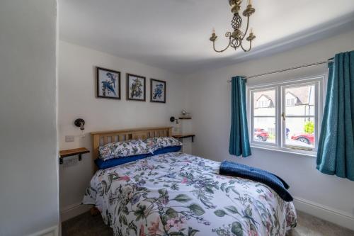 a bedroom with a bed and a window at Grade 2 Cottage 1 bedroom, Ludlow centre in Ludlow