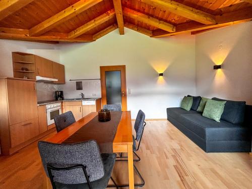 a living room with a table and a couch at Apart Hartl in Ried im Zillertal