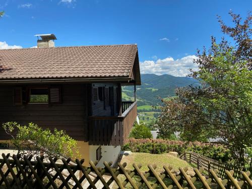 a house with a wooden fence in front of it at Japaner Haus in Weitenbach