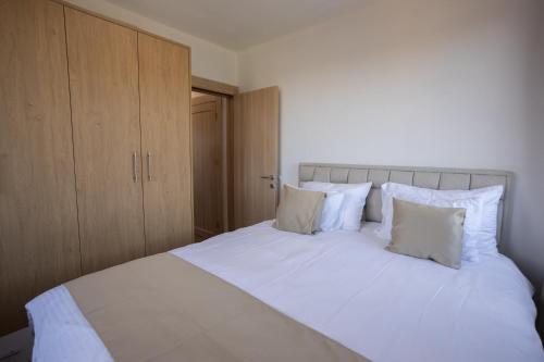 a bed with white sheets and pillows in a bedroom at Vila Oaza mira Golija in Golija