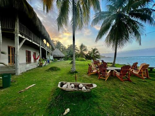 a resort yard with chairs and a bowl of rocks at Arrecifes Refugio Natural in Santa Marta
