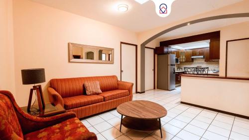 a living room with a couch and a table at New Apt in Centro GDL Near Cathedral & Attractions in Guadalajara