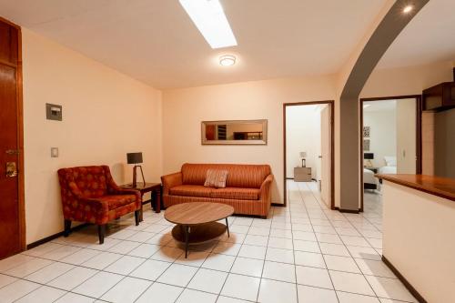 a living room with a couch and a table at New Apt in Centro GDL Near Cathedral & Attractions in Guadalajara