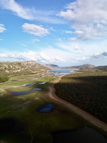 an aerial view of a river in a field at Casa Nengueta - Lapinha da Serra in Santana do Riacho