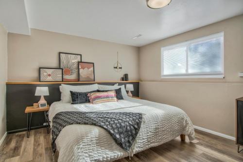 a bedroom with a large bed and a window at Kings Hideaway Stylish Apartment with Scenic View in Colorado Springs