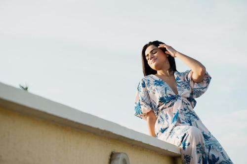 a woman sitting on the ledge of a building at Porto Bello Hotel Boutique in Puerto Colombia