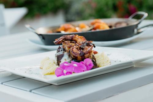 a plate of food on a table with food at Porto Bello Hotel Boutique in Puerto Colombia