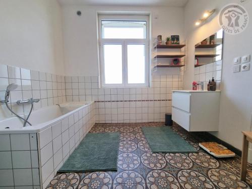 a bathroom with a tub and a sink and a window at Villa spacieuse avec jardin, terrasse, et équipements complets à Baives, proche Belgique et Val Joly - FR-1-510-218 in Baives