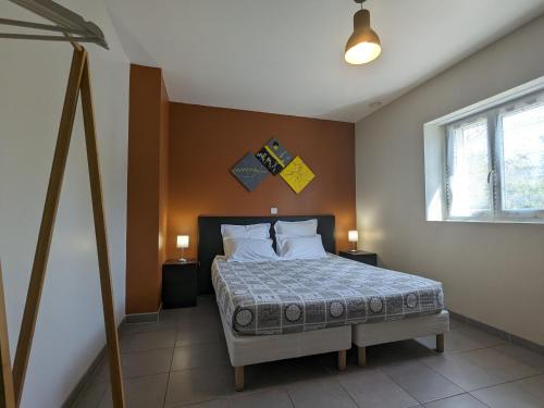 a bedroom with a bed with two night stands and a window at Chambre PMR avec Salle d'Eau Privative, Grande Lit, et Petit-Déjeuner Inclus in Neuvy-Saint-Sépulchre - FR-1-591-608 in Neuvy-Saint-Sépulchre