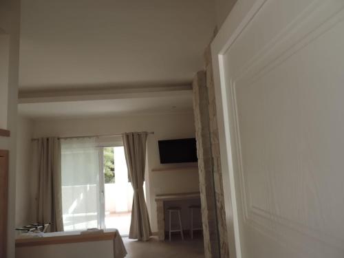 a living room with a window and a television at Luna D'Argento in Leporano Marina