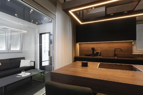 a kitchen with a sink and a couch in a room at Legacy Marine 3 - Serenity, luxury designer penthouse in Zadar