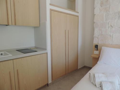 a small bedroom with a bed and a kitchen at Luna D'Argento in Leporano Marina