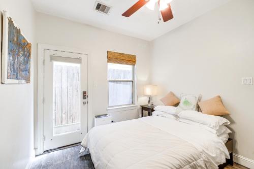 a white bedroom with a bed and a window at Dtwn Houston Home Near Stadiums WFH Friendly! in Houston