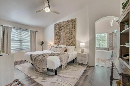 a white bedroom with a bed and a bath tub at Kiva Cove Pool & Sun Loungers on the Patio in Mesa