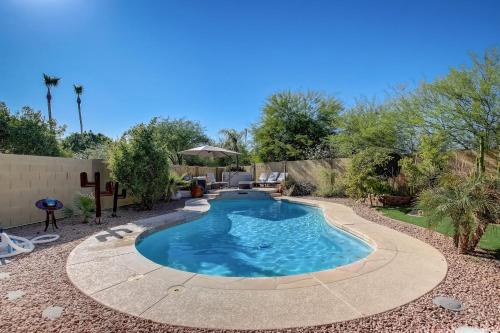 a pool in a yard with a patio at Kiva Cove Pool & Sun Loungers on the Patio in Mesa
