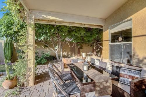 an outdoor patio with a table and chairs and trees at Kiva Cove Pool & Sun Loungers on the Patio in Mesa