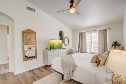 a white bedroom with a bed and a mirror at Kiva Cove Pool & Sun Loungers on the Patio in Mesa