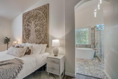 a white bedroom with a bed and a bath tub at Kiva Cove Pool & Sun Loungers on the Patio in Mesa
