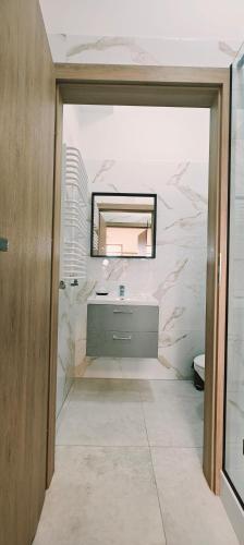a bathroom with a sink and a mirror at 4 Kąty Koronowo in Koronowo