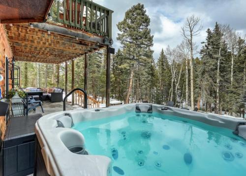 a hot tub on the patio of a house at Pinetop Cabin Hot Tub BBQ Arcade Scenic Escape in Florissant
