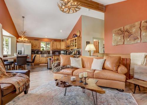 a living room with a couch and a table at Pinetop Cabin Hot Tub BBQ Arcade Scenic Escape in Florissant